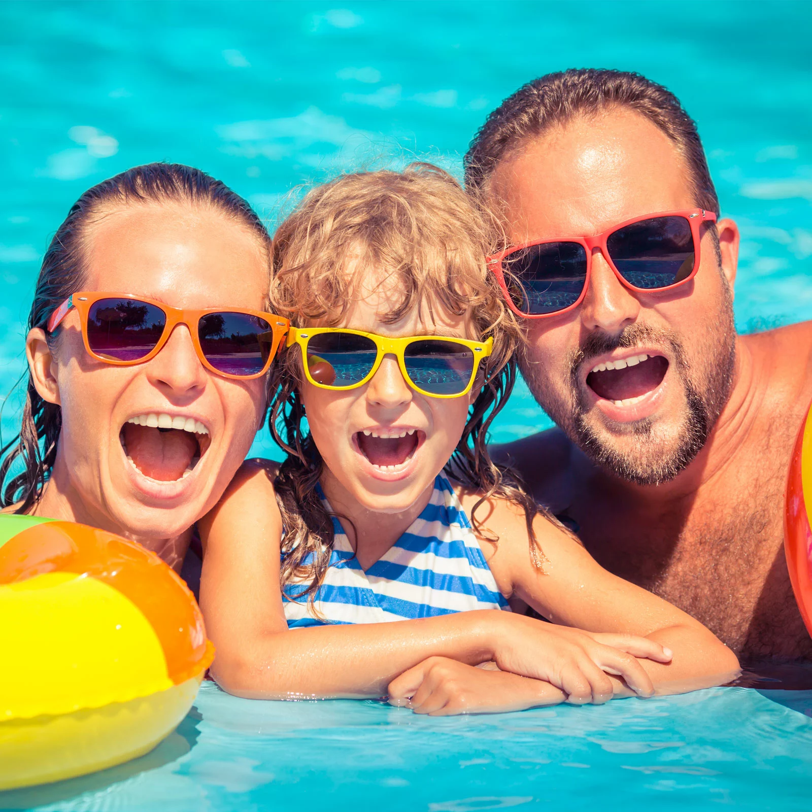 family in outdoor swimming pool
